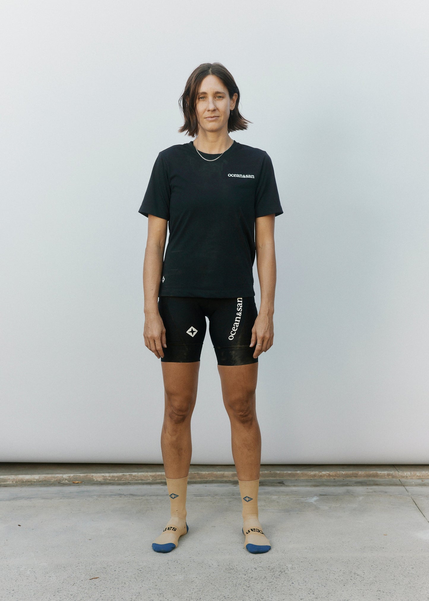 model wearing casual cycling shirt, cycling shirt, womens cycling bib shorts